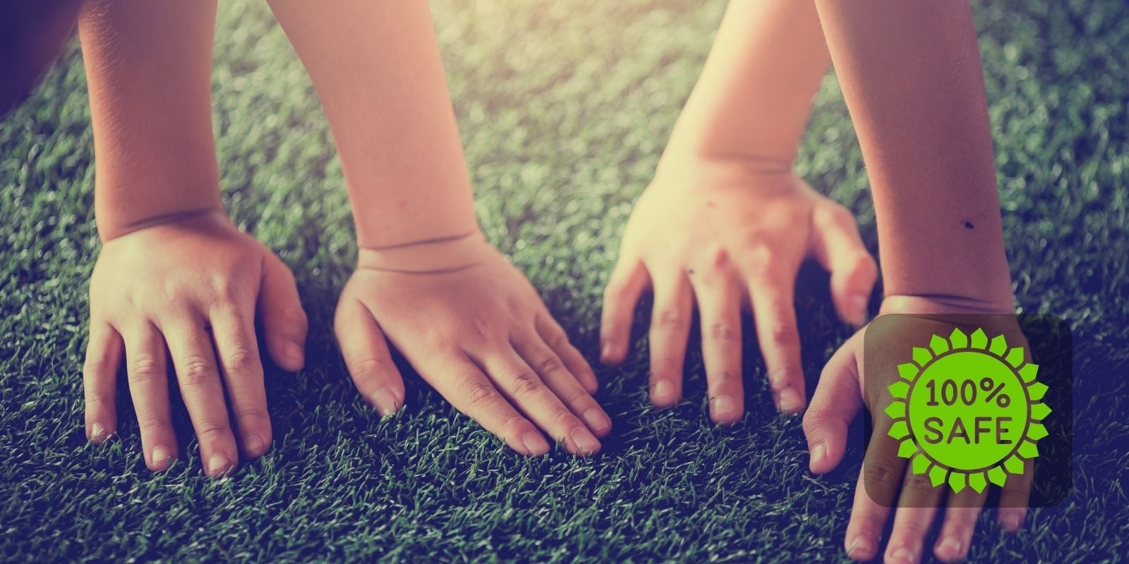 Children’s hands touching artificial grass with a green badge stating 100% safe, highlighting non-toxic and kid-friendly turf. Coronado Platinum Turf for outdoor spaces.